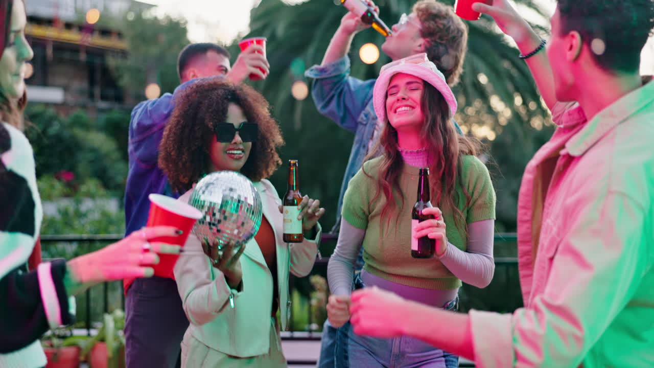 Friends celebrating together at an outdoor party with music and drinks