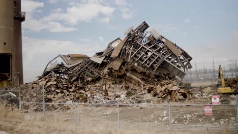 Old-demolished-coal-power-plant-being-demolished-with-smoke-stacks-still-standing