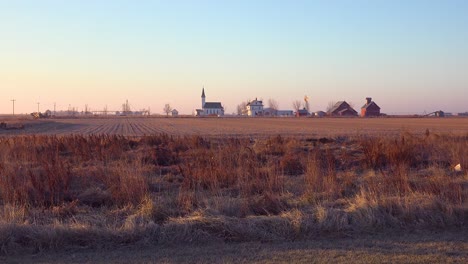 establishing shot of a classic beautiful small town farmhouse farm and barns in rural midwest america york nebraska