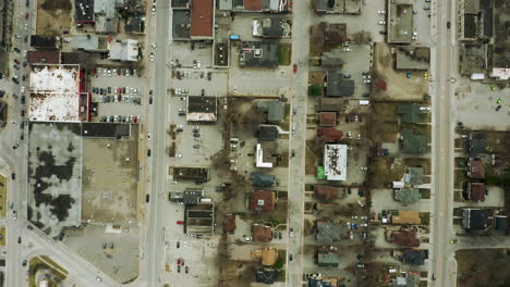 grid of downtown city with homes and various buildings and long straight roads