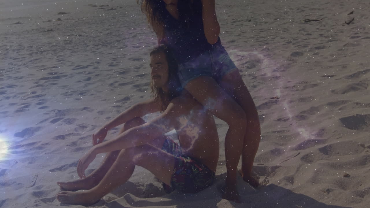 man and woman posing at beach, overlaying straw hat icon and nebula graphics in technology