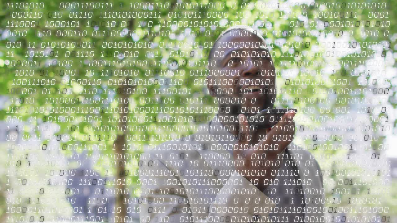 Man speaking into phone in plaza, recording for tech while binary overlay growing, obscuring view