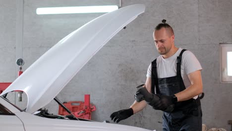 mecánico de automóviles trabajando en un coche en un garaje
