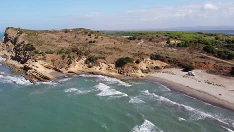 porto novo and hidrovor beach, albania - aerial of camper van, cliffs and coastline