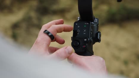 toque masculino con los dedos oled pantalla táctil en el estabilizador gimbal electrónico