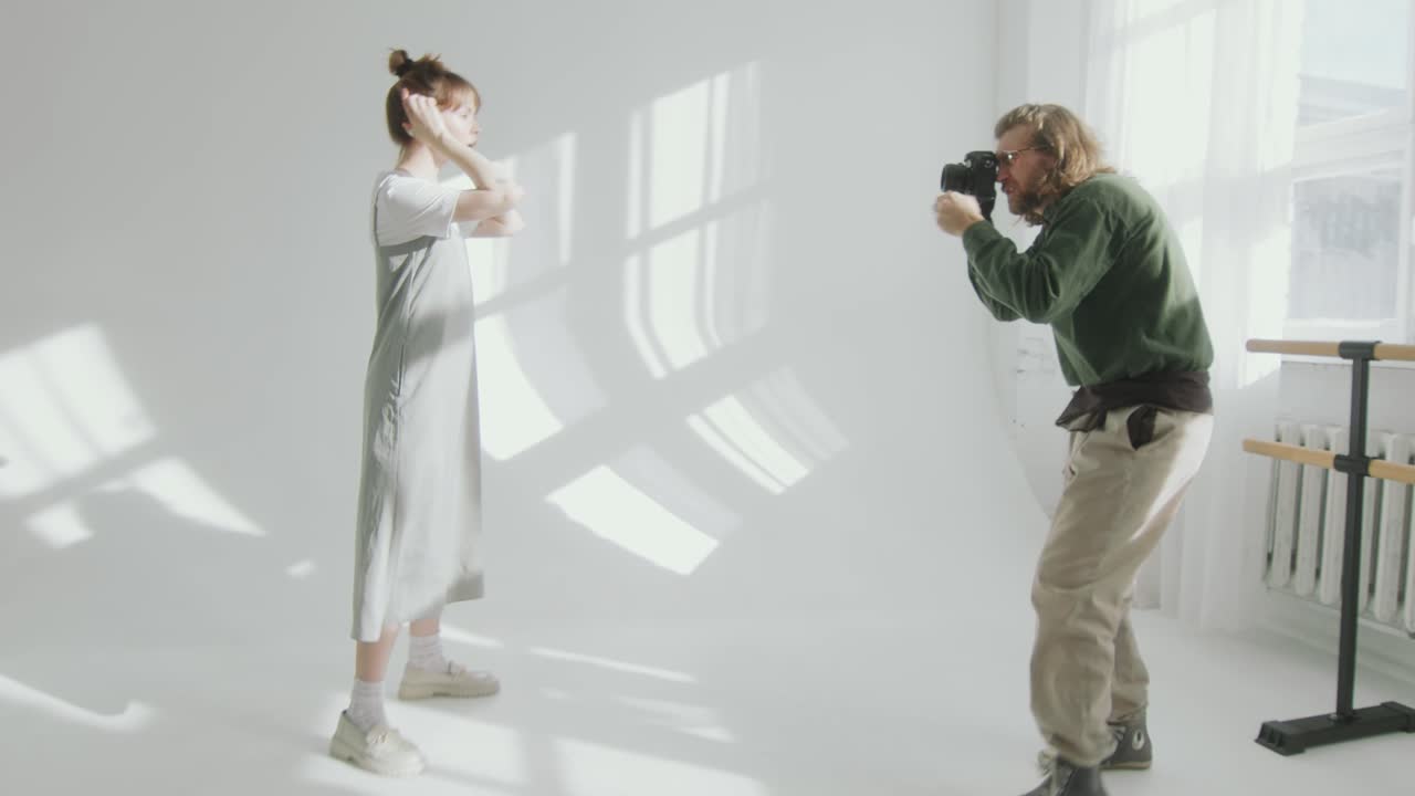 Photographer Giving Directions to Model during Photo Session in Studio