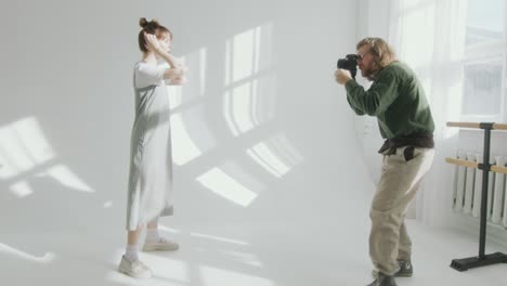 photographer giving directions to model during photo session in studio