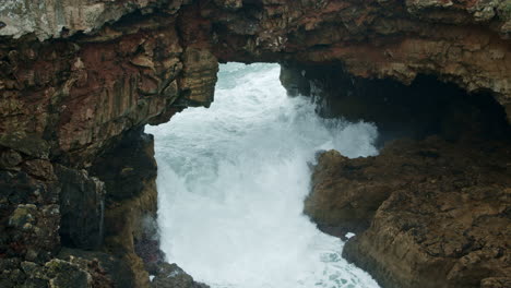 slow motion: sea wave crashing at la boca do inferno in cascais, portugal