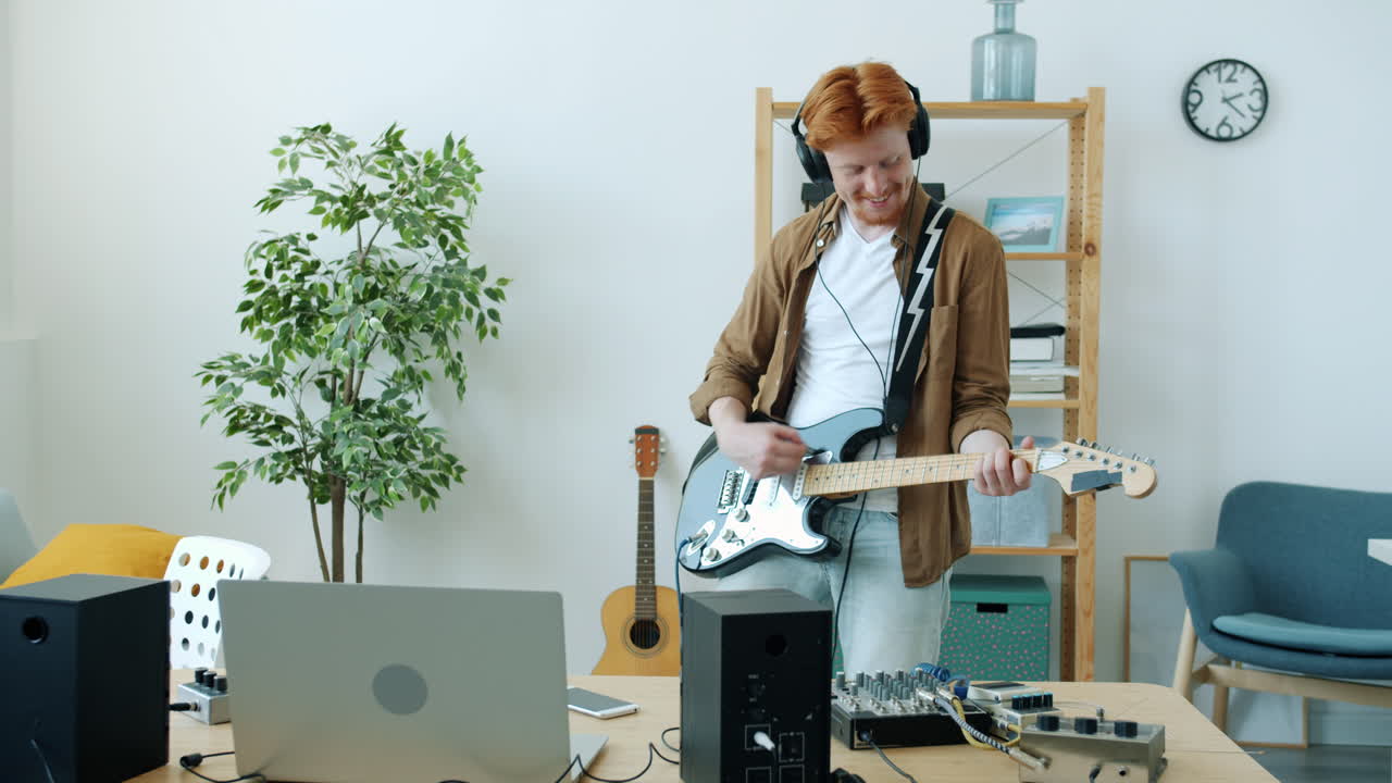 Man Playing Electric Guitar in Home Studio