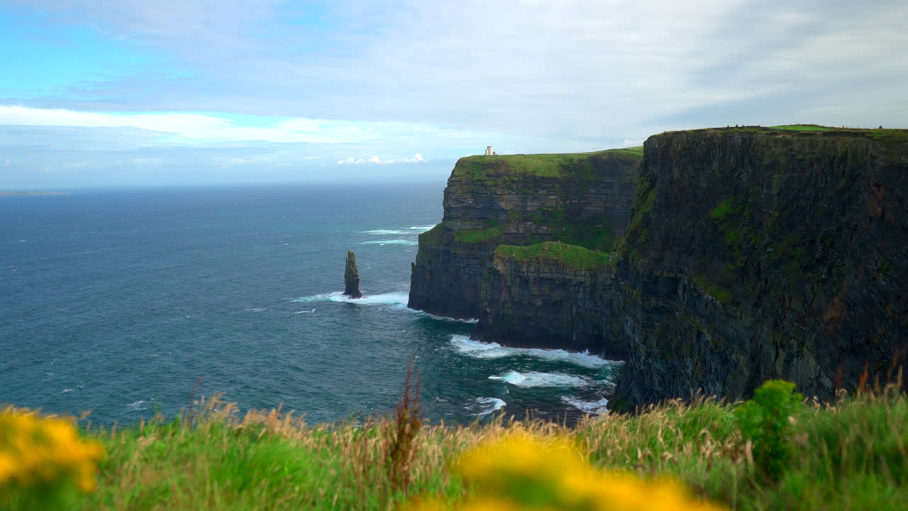 Steep, windswept cliffs dominate the horizon as the Cliffs of Moher stand tall over the Atlantic. This awe-inspiring coastal view highlights Ireland’s untamed beauty.
