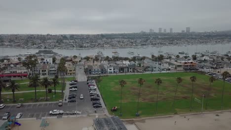 Grassy-Park-at-Beach-Aerial-Horizontal-Dolly-Movement-Past-Palm-Trees