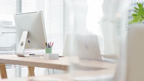 empty desk with computer and laptop