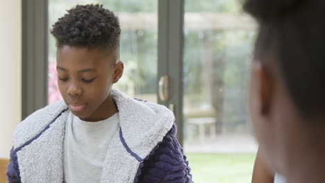 Young-Boy-and-His-Sister-Talking-Over-Family-Breakfast