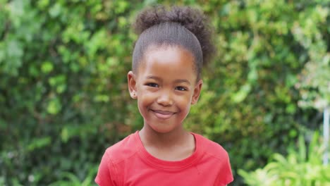 Animation-of-happy-african-american-girl-looking-at-camera-in-garden