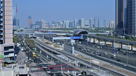 a dubai metro train departs the station, heading to its next stop along sheikh zayed road amidst the traffic flow in dubai, uae