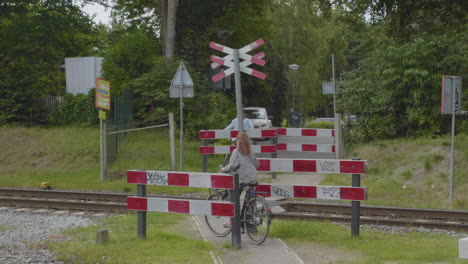 two cyclists passing a unguarded level crossing in the netherlands