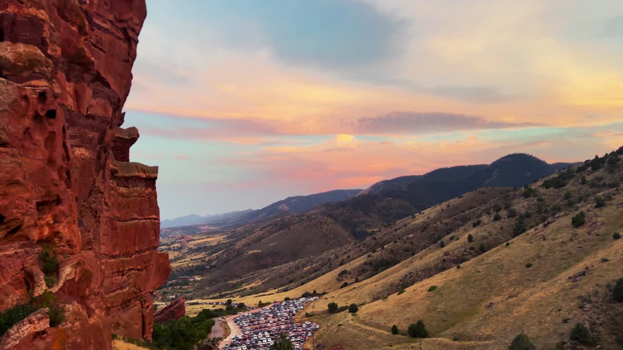 Summer sunset front range Morrison Colorado Red Rocks Amphitheater Park golden hour concert venue orange vibrant clouds foothills Evergreen Golden parking lot static shot