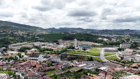 aerial - panoramic view of guimarães, portugal, featuring estádio d. afonso henriques, cityscape, and rolling green hills