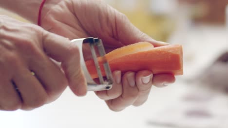 cook slicing carrot with cutter