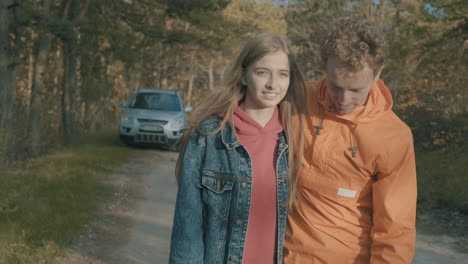 young female and male hikers walking