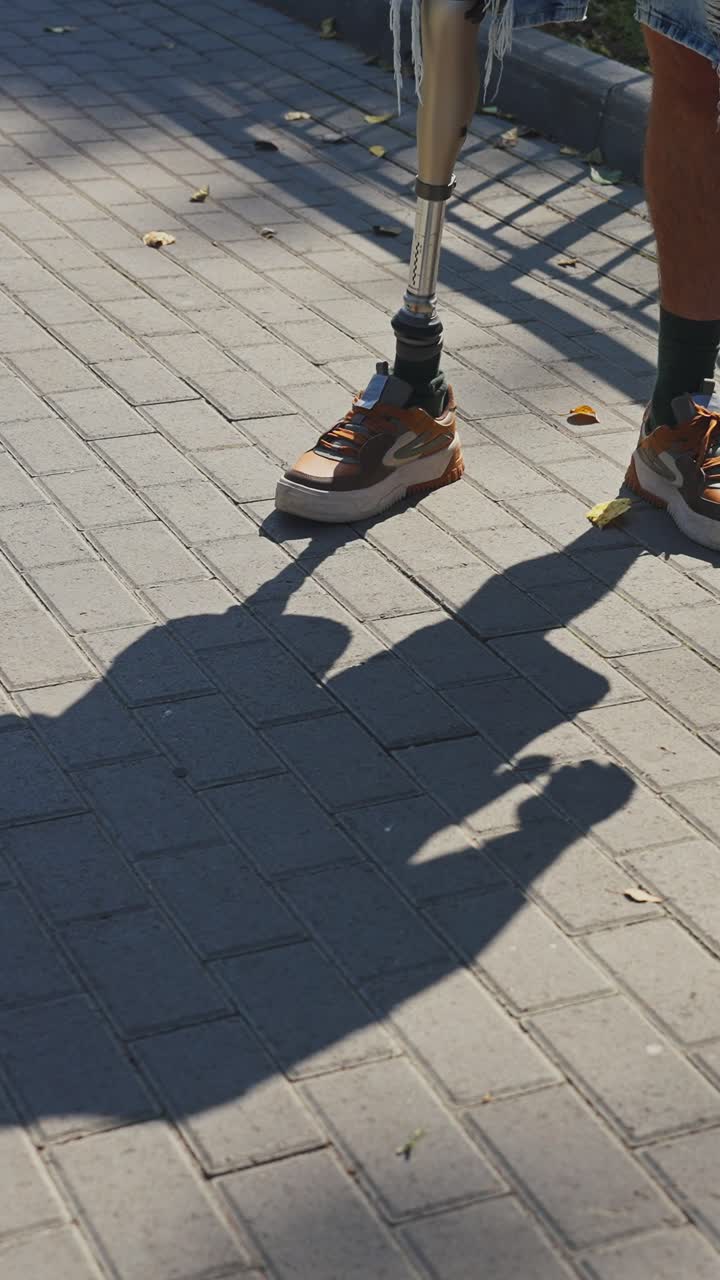 Person with Prosthetic Leg on a Sidewalk