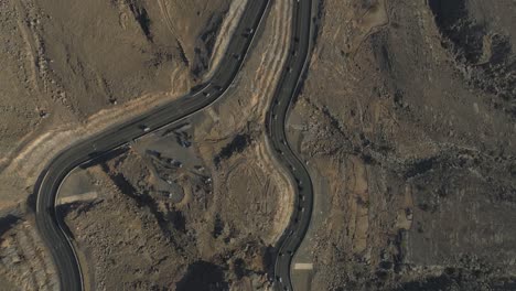 Cinematic-Revealing-drone-shot-of-a-Zig-Zag-roads-in-a-Rocky-mountain