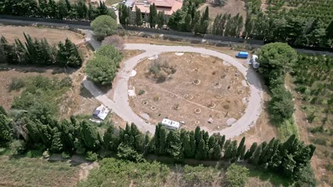 aerial tops down camping car parking location between trees at ortaffa in southern france.