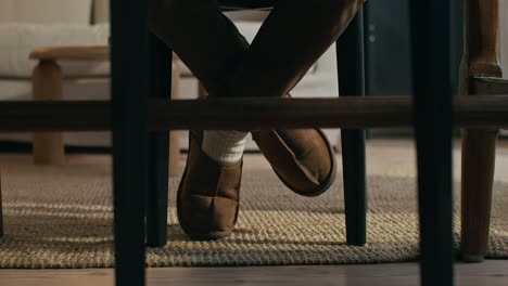 person sitting in a chair with feet crossed