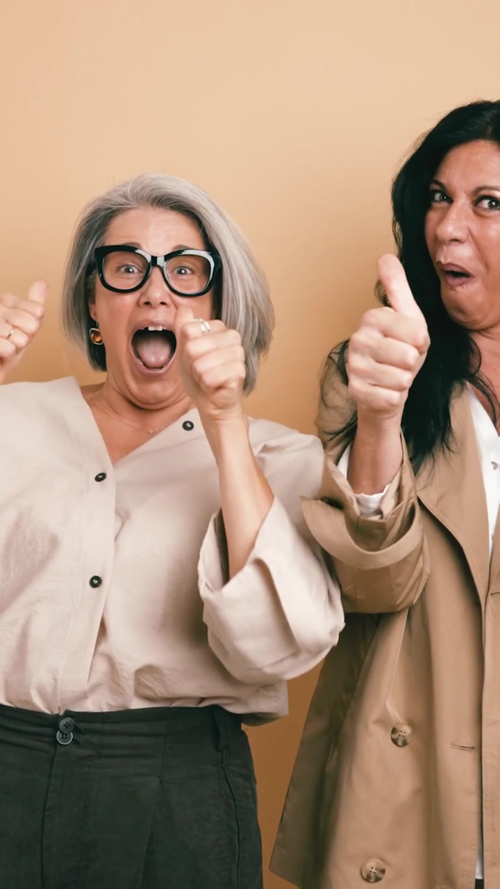 Two Excited Mature Women Celebrating Success Together