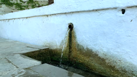 clean water pouring from the tube into the trench