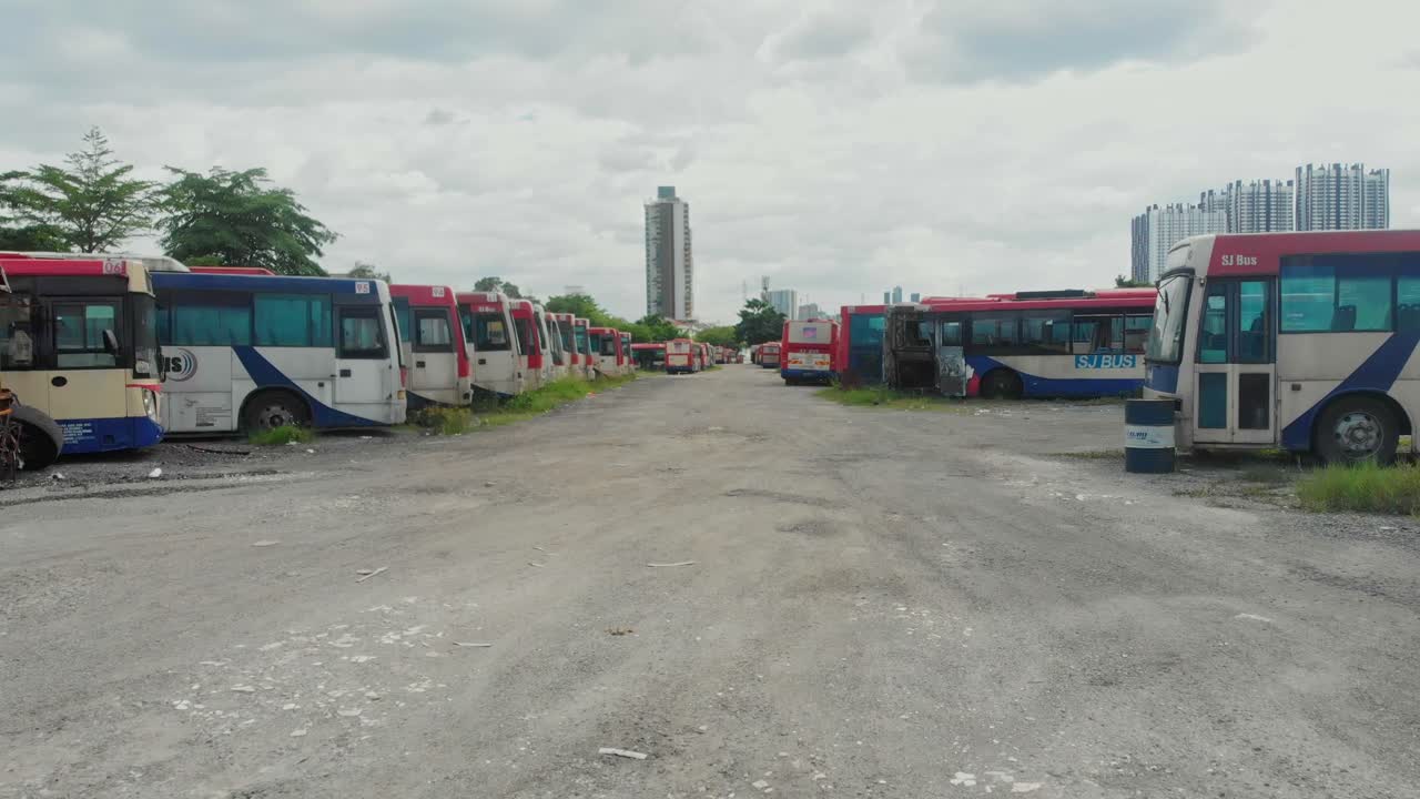 Aerial view of old buses resting in abandoned graveyard in Kuala Lumpur Malaysia
