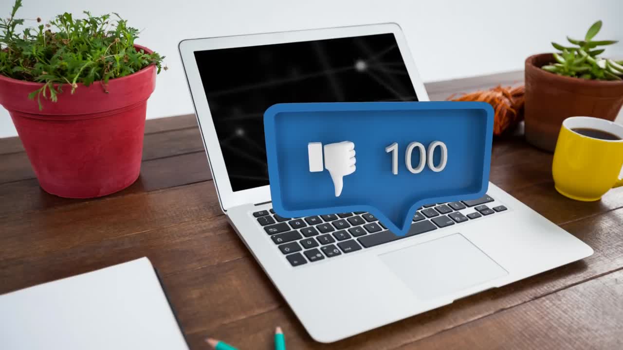 pulgares hacia abajo símbolo y el aumento de los números sobre el portátil y las plantas en la mesa