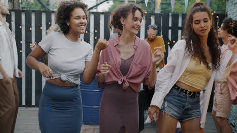friends dancing at a backyard party