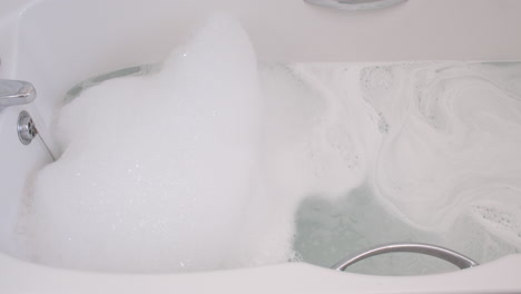 relaxing bubble bath in a white bathtub