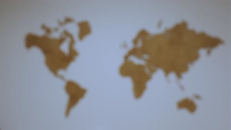 blurred background world map silhouette. wooden world map on the wall.