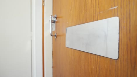 small parcel being dropped through a mail slot in the door