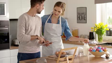 Happy-couple-preparing-a-cake-for-Easter