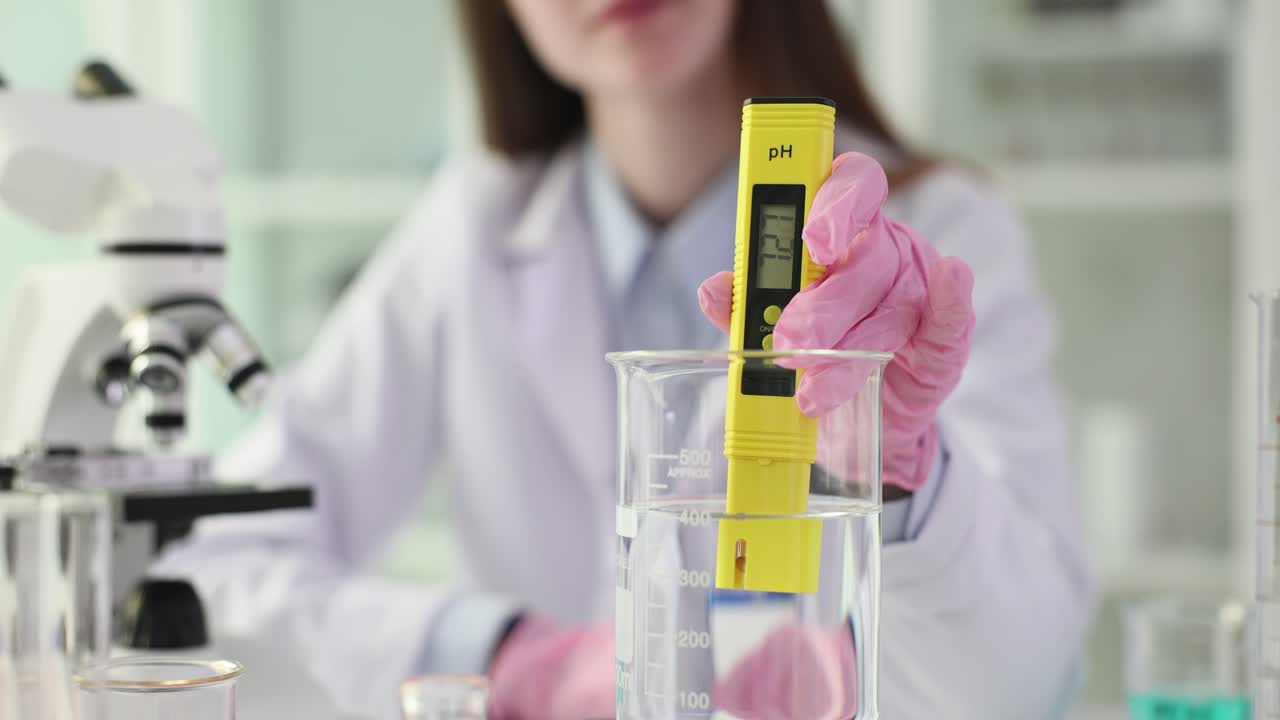 A person measuring pH levels in a laboratory