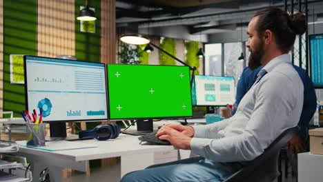 vertical video business manager working on report writing next to chroma key screen