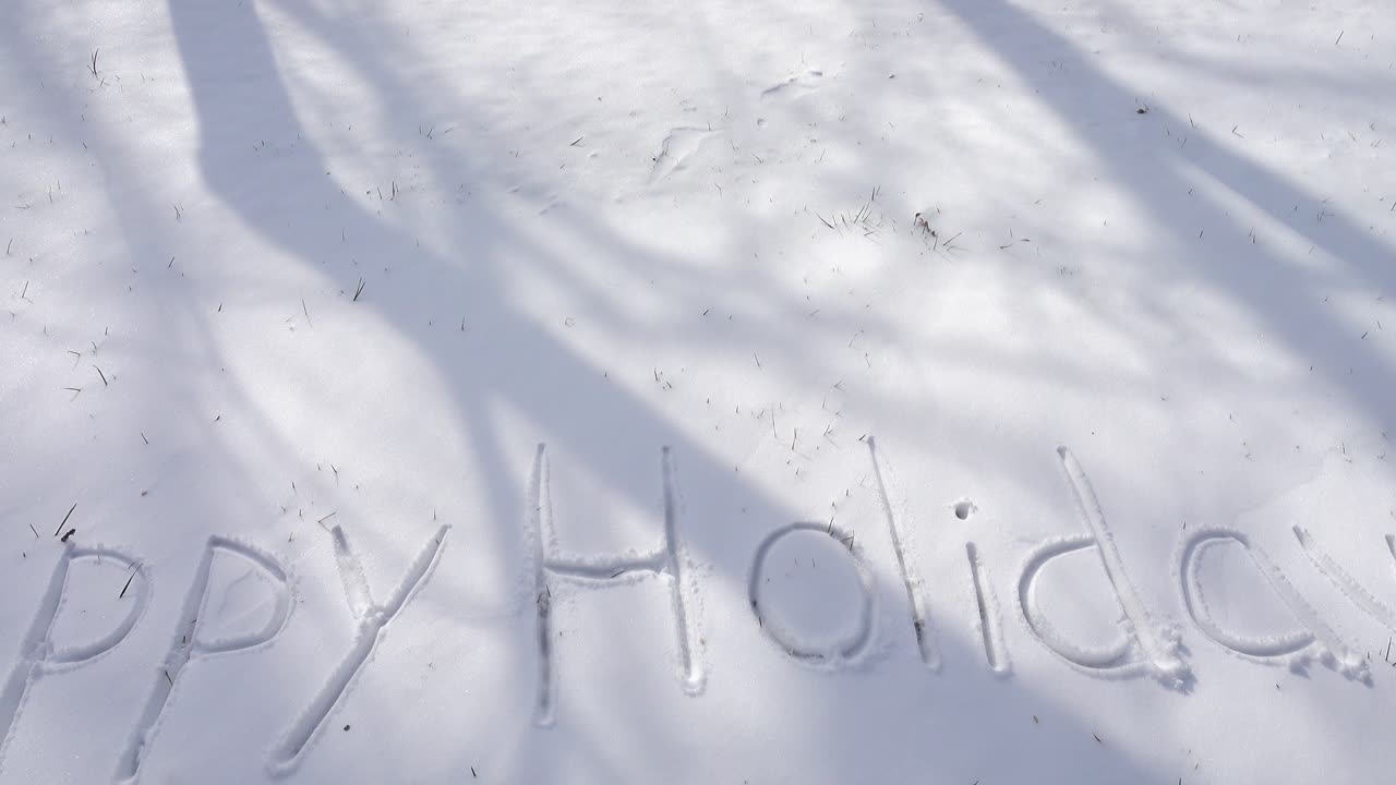 Inscription of happy holidays on snow