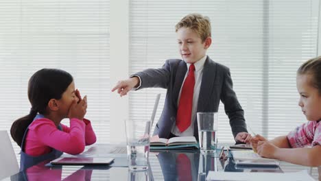 Kids-as-business-executives-having-a-meeting-in-the-board-room-4K-4k