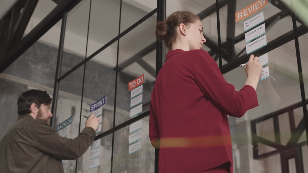 Man and Woman Working on Notes