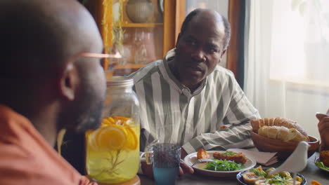 african american men chatting at family dinner