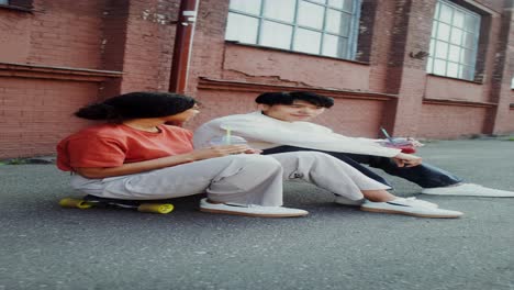 couple relaxing on skateboard