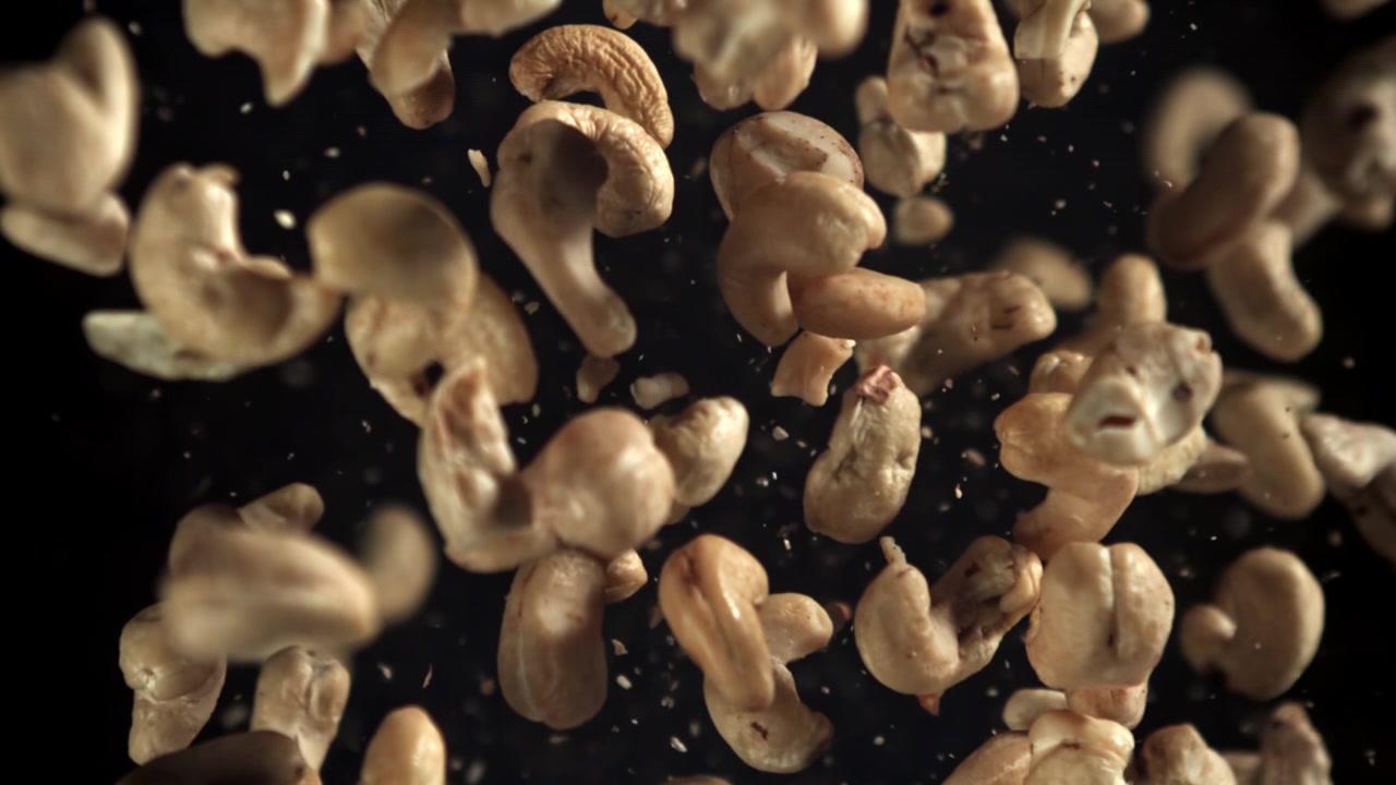 Cashew Nuts Falling in Slow Motion on a Black Background