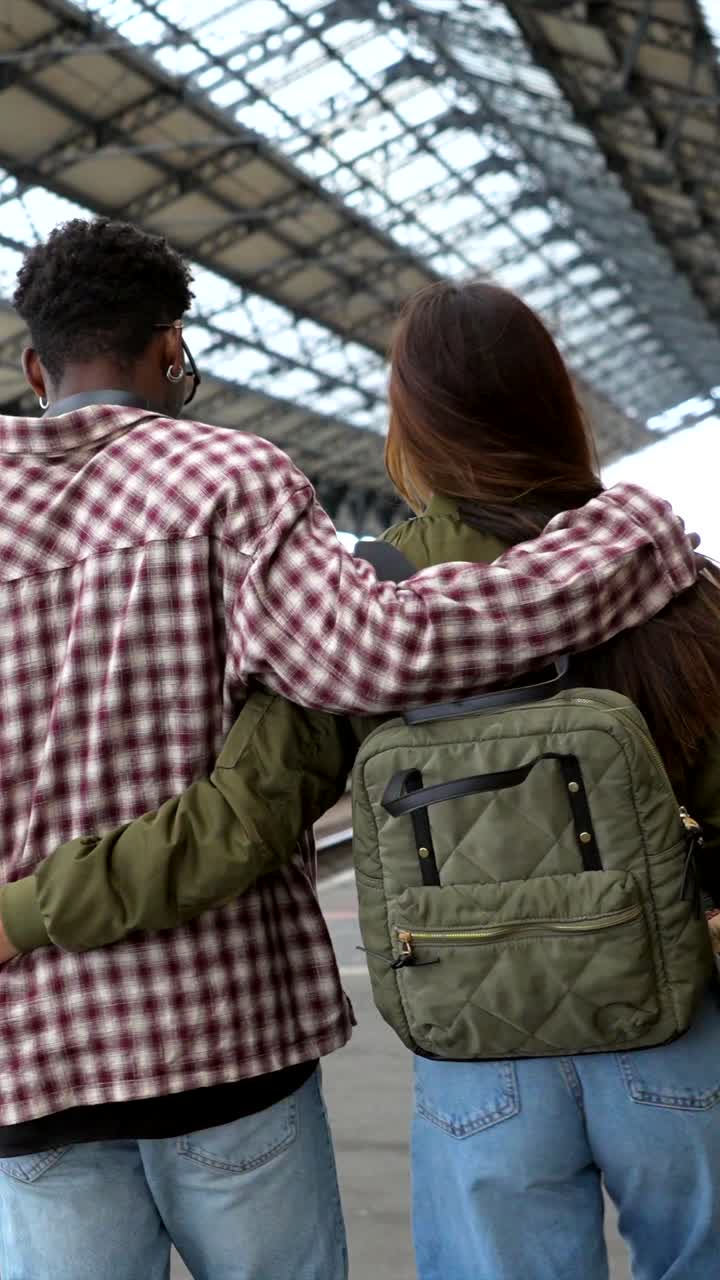 A Couple Embracing at a Train Station