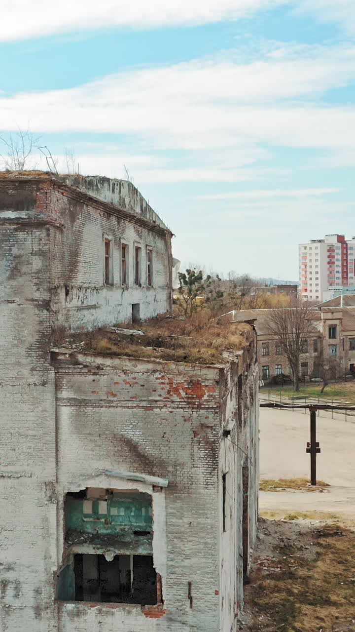 Old abandoned apartment buildings. Broken windows in old abandoned industrial building Vertical video