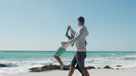 Couple-and-their-son-enjoying-free-time-on-the-beach-together