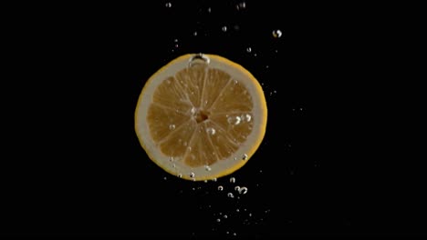 lemon falling into water super slowmotion, black background, lots of air bubbles, 4k240fps