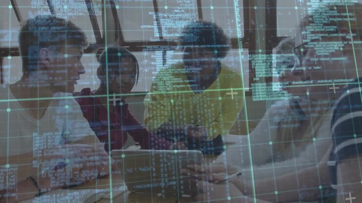 Teen students collaborating on code around table girl gesturing toward laptop showing code overlay